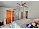 Bright bedroom features a ceiling fan, four-poster bed, and ensuite bathroom and walk-in closet at 209 Tamarack Dr, Henderson, NV 89002