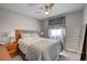 Cozy bedroom featuring a comfortable bed, ceiling fan, natural light, and simple decor for relaxation at 209 Tamarack Dr, Henderson, NV 89002