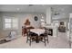 Open dining area with tiled floors, neutral walls, shuttered windows, view to fireplace, and stylish furniture at 209 Tamarack Dr, Henderson, NV 89002