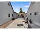 Side yard between homes, with gate, trash can and building materials at 209 Tamarack Dr, Henderson, NV 89002