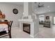 Fireplace with decorative mantel that separates the living room and dining area in a well-lit home at 209 Tamarack Dr, Henderson, NV 89002