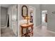 Hallway with white doors and tile flooring showcases a decorative mirror and access to other rooms at 209 Tamarack Dr, Henderson, NV 89002