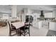 Spacious kitchen with white cabinets, island, stainless appliances, tile floors, and dining area with fireplace at 209 Tamarack Dr, Henderson, NV 89002