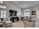 Well-lit living room with a modern television, comfortable sofas, and natural light through shuttered windows at 209 Tamarack Dr, Henderson, NV 89002