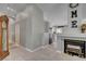Open-concept living room featuring tile flooring, a fireplace, and seamless access to the kitchen at 209 Tamarack Dr, Henderson, NV 89002