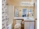 Cozy bathroom featuring a shower-tub combo, floral shower curtain and well-lit vanity with ample space at 2104 Kendall Hill Ave, Las Vegas, NV 89106