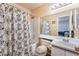 Bathroom with a shower and tub combination and patterned shower curtain at 2104 Kendall Hill Ave, Las Vegas, NV 89106