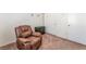 Comfortable room with carpeted floors, a cozy recliner and storage cabinet next to sliding closet doors at 2104 Kendall Hill Ave, Las Vegas, NV 89106