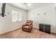 Neutral bedroom with a relaxing recliner, mounted television, storage, and large, sunlit window at 2104 Kendall Hill Ave, Las Vegas, NV 89106