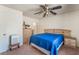 Bedroom with neutral carpet, large dresser, nightstands and blue comforter set at 2104 Kendall Hill Ave, Las Vegas, NV 89106