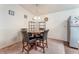 Dining area features a round wooden table, four chairs, and neutral carpet at 2104 Kendall Hill Ave, Las Vegas, NV 89106