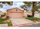 Single-story home with a two-car garage and desert landscaping at 2104 Kendall Hill Ave, Las Vegas, NV 89106