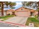 Cozy single-story home with a two-car garage, desert landscaping, and a cozy front porch at 2104 Kendall Hill Ave, Las Vegas, NV 89106