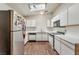 Well-lit kitchen features white cabinets, stainless appliances, and wood-look flooring at 2104 Kendall Hill Ave, Las Vegas, NV 89106
