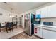Functional kitchen featuring white cabinets, stainless steel appliances, and dining area at 2104 Kendall Hill Ave, Las Vegas, NV 89106