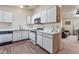 Bright kitchen with white cabinets, stainless steel appliances, and laminate flooring at 2104 Kendall Hill Ave, Las Vegas, NV 89106