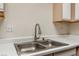 Close up on the stainless steel sink with brushed nickel faucet and laminate countertops at 2104 Kendall Hill Ave, Las Vegas, NV 89106