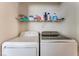 Laundry room features a washer, dryer, and a shelf for storage at 2104 Kendall Hill Ave, Las Vegas, NV 89106