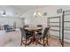 Open floorplan living room with wood table and chairs, ceiling fan and extra seating at 2104 Kendall Hill Ave, Las Vegas, NV 89106