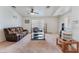 Bright living room featuring neutral carpet, ceiling fan, and comfortable seating at 2104 Kendall Hill Ave, Las Vegas, NV 89106