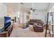 Spacious living room with neutral carpet, ceiling fan, and a comfortable seating arrangement at 2104 Kendall Hill Ave, Las Vegas, NV 89106