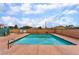 Community swimming pool with clear water, spa and lounging area, surrounded by a brick wall at 2104 Kendall Hill Ave, Las Vegas, NV 89106