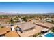 Expansive property featuring a refreshing pool, desert landscaping, and stunning views of surrounding city at 211 E Kimberly Dr, Henderson, NV 89015