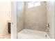 Bright bathroom featuring a tiled bathtub and shower area with sleek fixtures and modern design at 211 E Kimberly Dr, Henderson, NV 89015