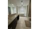 Elegant bathroom with freestanding tub, vanity with storage, and tiled floors at 211 E Kimberly Dr, Henderson, NV 89015