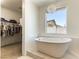 Soaking tub with view, and large closet with hanging clothes at 211 E Kimberly Dr, Henderson, NV 89015