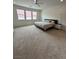 Bright bedroom with large windows, neutral carpet, and a comfortable bed at 211 E Kimberly Dr, Henderson, NV 89015