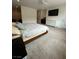 Cozy bedroom featuring a large bed, soft carpet, and a wall-mounted TV at 211 E Kimberly Dr, Henderson, NV 89015