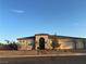 Inviting single-story home with stone accents, desert landscaping, and a three-car garage at 211 E Kimberly Dr, Henderson, NV 89015