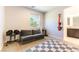 Home gym area featuring a comfortable gray couch, weights, and exercise equipment for convenient workouts at 211 E Kimberly Dr, Henderson, NV 89015
