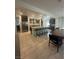 Bright kitchen boasts a large center island with barstool seating, stainless steel appliances, and tile flooring at 211 E Kimberly Dr, Henderson, NV 89015