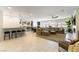Bright, open-concept living room featuring tile floors, a large sectional sofa, and access to a modern kitchen at 211 E Kimberly Dr, Henderson, NV 89015