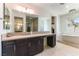 Bathroom vanity with double sinks, soaking tub and walk-in shower at 211 E Kimberly Dr, Henderson, NV 89015