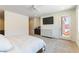 Bright main bedroom featuring outdoor access and a dresser with mirror at 211 E Kimberly Dr, Henderson, NV 89015