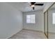 A bright, empty bedroom with a window, ceiling fan, closet, and wood laminate flooring at 2116 Cameron St, Las Vegas, NV 89102