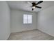 A bright, empty bedroom with a window, ceiling fan, and wood laminate flooring at 2116 Cameron St, Las Vegas, NV 89102