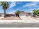Charming single-story home featuring desert landscaping, an attached garage, and mature palm trees at 2116 Cameron St, Las Vegas, NV 89102