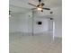 Bright, spacious living room with tiled floors, ceiling fan, and a mirrored wall at 2116 Cameron St, Las Vegas, NV 89102