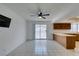 Bright living room features neutral paint, tile flooring, a ceiling fan, and adjoins Kitchen at 2116 Cameron St, Las Vegas, NV 89102