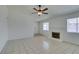 Bright living room features neutral paint, tile flooring, ceiling fan, and cozy fireplace at 2116 Cameron St, Las Vegas, NV 89102