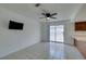 Bright living room features neutral paint, tile flooring, a ceiling fan, and access to backyard at 2116 Cameron St, Las Vegas, NV 89102