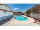 Backyard pool with clear blue water and a concrete surround, enclosed by a block wall with flowering shrubbery at 2116 Cameron St, Las Vegas, NV 89102