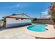Backyard pool with clear blue water, with house and block wall in the background, under a clear blue sky at 2116 Cameron St, Las Vegas, NV 89102