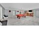 Finished basement boasting a pool table, a bar with seating, and marble flooring at 2131 Diamond Bar Dr, Las Vegas, NV 89117