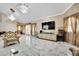 Elegant living room with marble floors, and luxury furniture with large windows allowing ample natural light at 2131 Diamond Bar Dr, Las Vegas, NV 89117