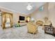 Spacious living room with large TV, marble floors, gold accents, and elegant chandelier at 2131 Diamond Bar Dr, Las Vegas, NV 89117
